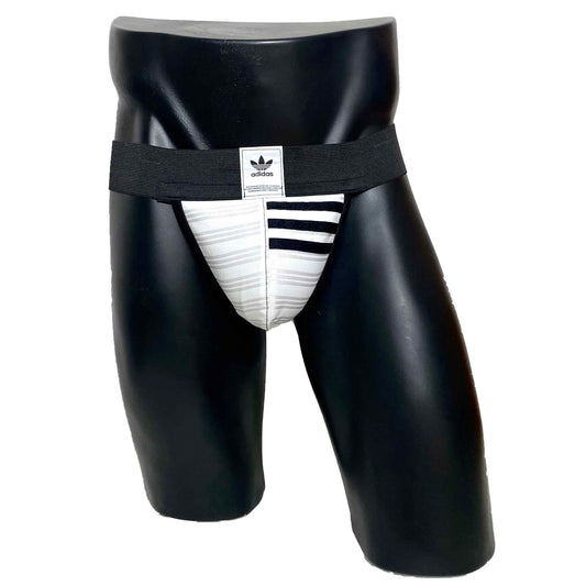 A jockstrap made from up-cycled Adidas tracksuit material, featuring white straps with black detailing, worn on a mannequin.